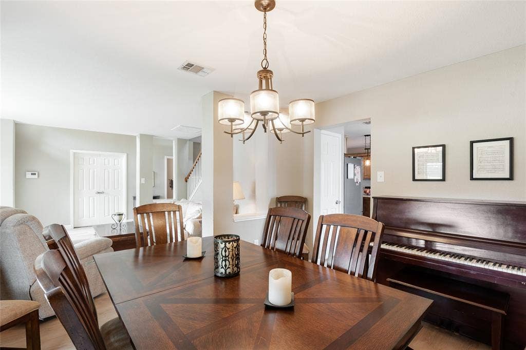 1608 Mountain Laurel Drive, Keller, TX 76248 bright dining space with large window and elegant chandelier