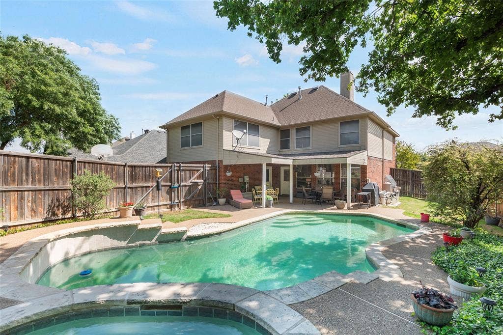 1608 Mountain Laurel Drive, Keller, TX 76248 Rear view of property featuring a patio area, a fenced backyard, brick siding, a chimney, and an in-ground hot tub