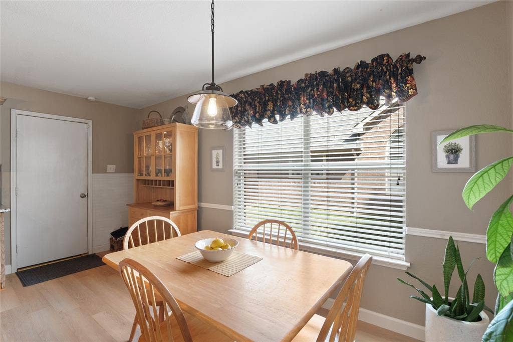 1608 Mountain Laurel Drive, Keller, TX 76248 Eat in breakfast area with wood-finish flooring, a contemporary pendant light fixture, and a window with horizontal blinds