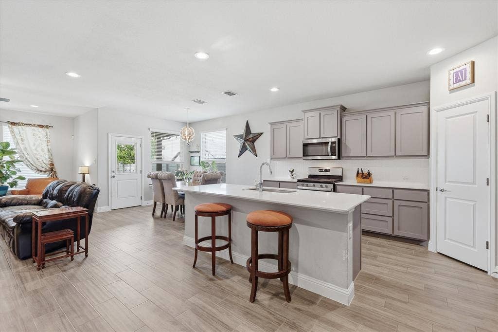 Spacious large kitchen with gas cooking and island seating perfect for entertaining