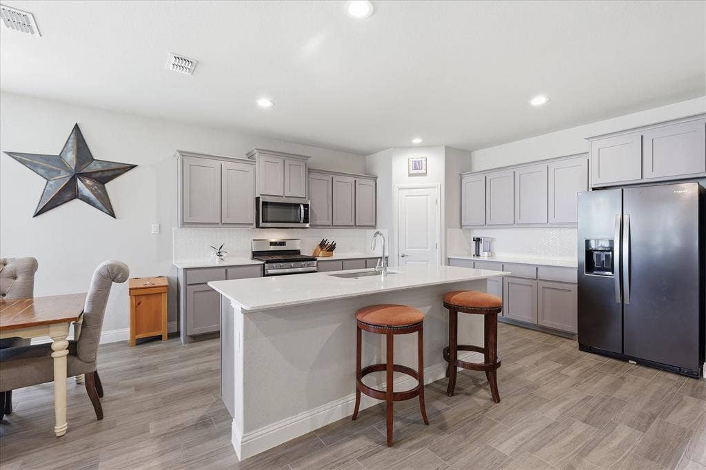 Stainless appliances, kitchen island and beautiful cabinetry