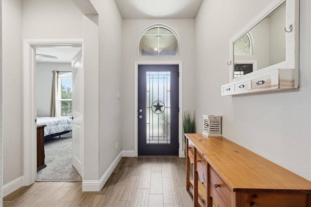 Tall ceilings and a Texas star welcome you inside this single story home