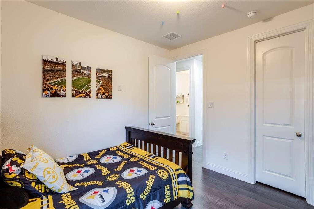 Secondary bedrooms downstairs with engineered hardwoods.
