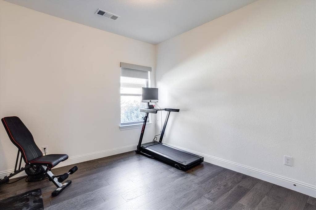 Secondary bedroom currently being used as a home gym.