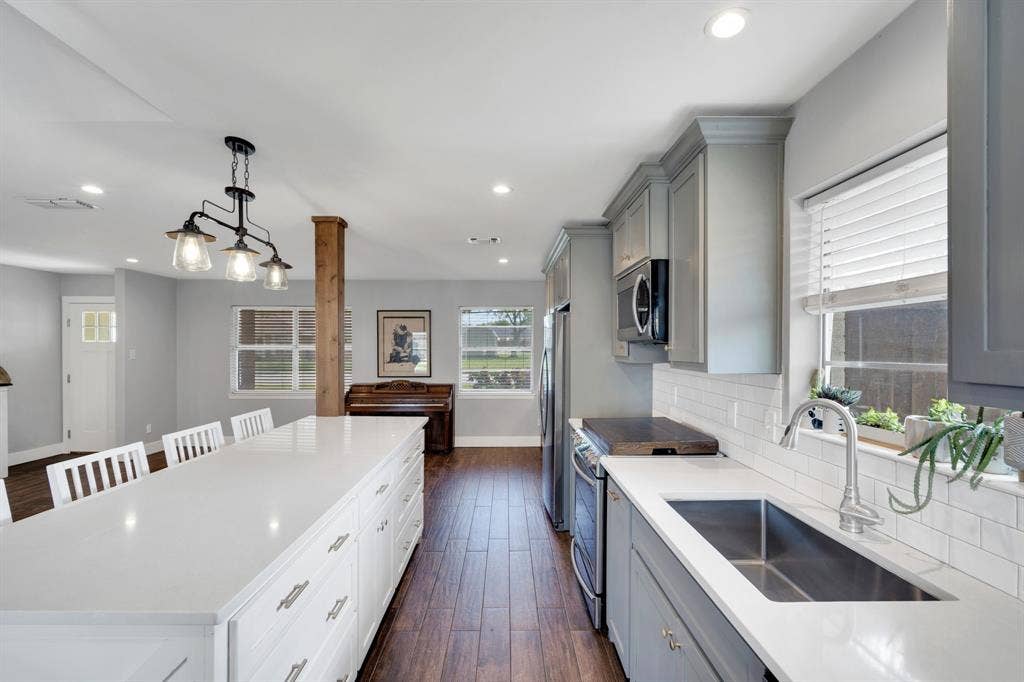 106 Hillcrest Drive, Midlothian, TX 76065 Kitchen view with cedar columns, updated cabinetry, modern conveniences