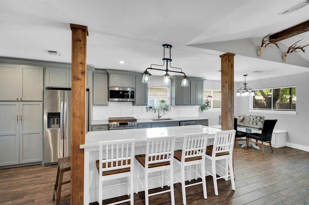 106 Hillcrest Drive, Midlothian, TX 76065 Kitchen view with cedar columns, updated cabinetry, modern conveniences