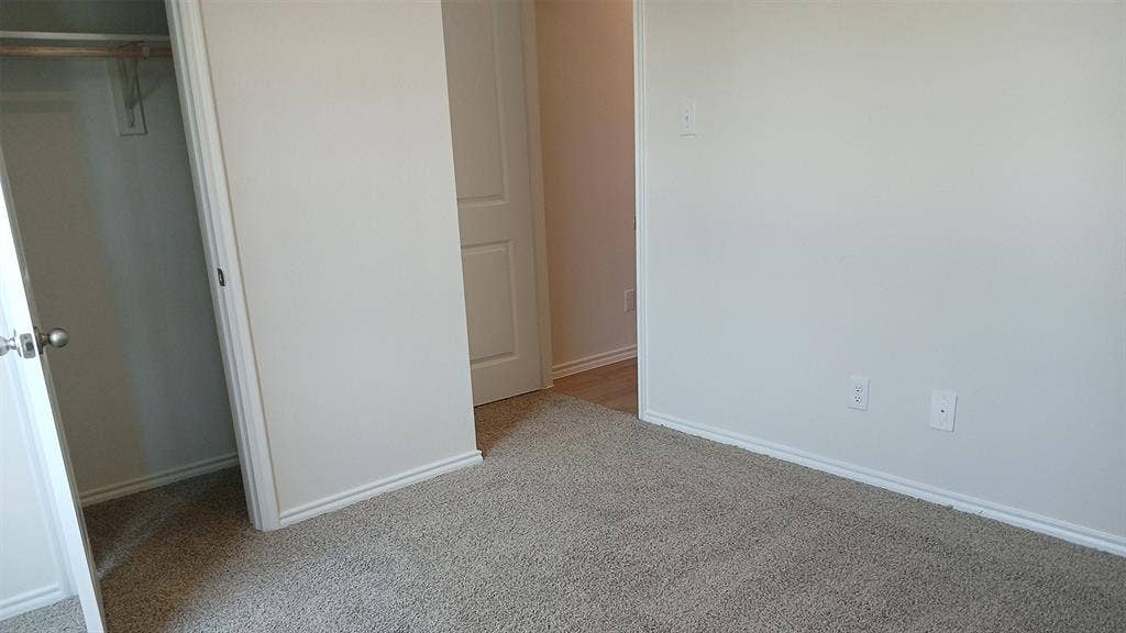 223 Whispering Pine Drive, Royse City, TX 75189 Light beige wall-to-wall carpeting throughout this space, featuring white baseboards and trim