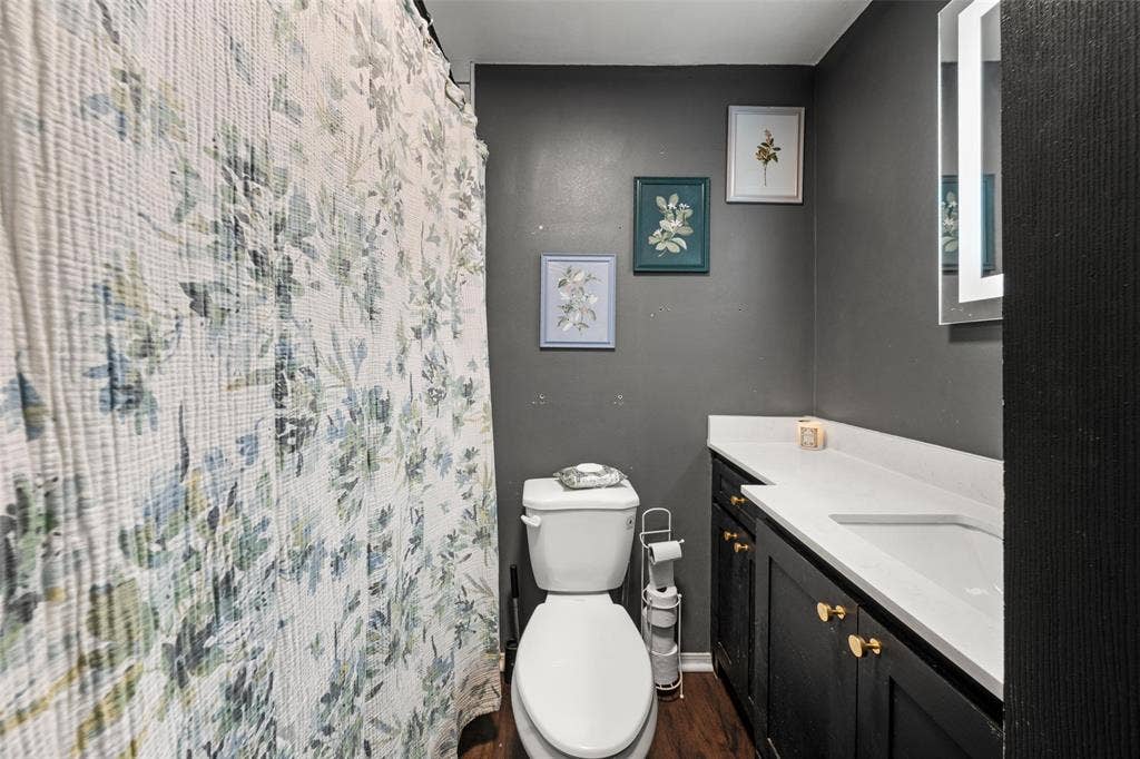 1207 Pembrook Drive, Waco, TX 76710 Full bath with vanity, curtained shower, and dark wood-type flooring