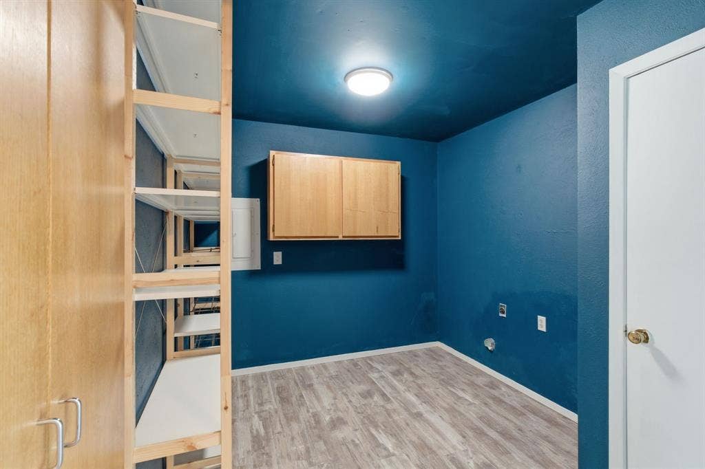 Empty room with light wood-style floors and baseboards
