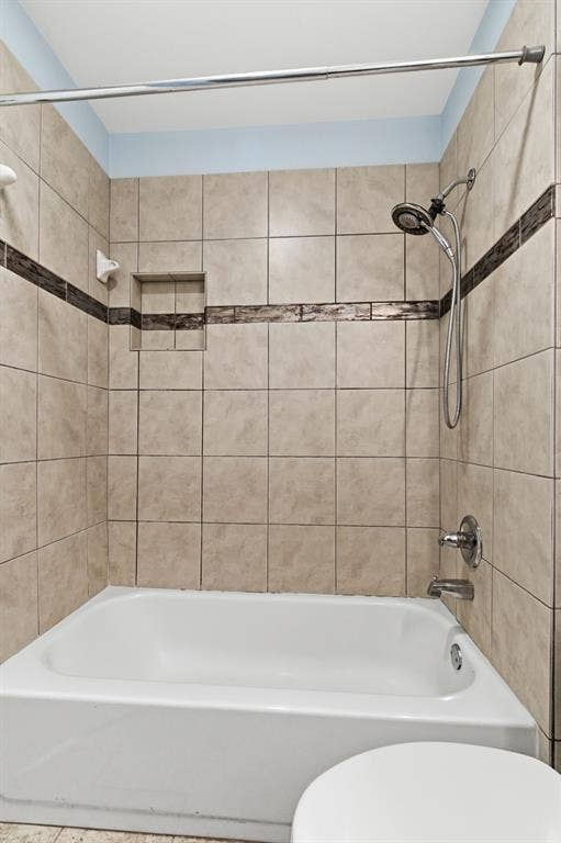 Full bathroom featuring toilet and shower / tub combination