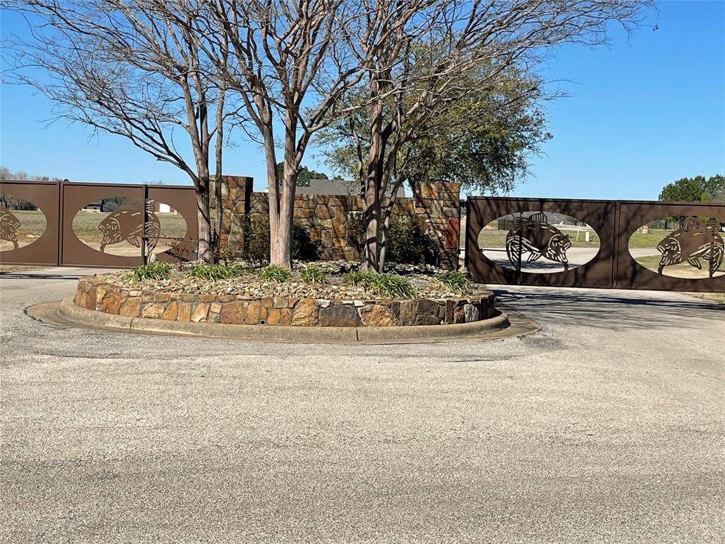 5455 Saddle Ridge Court, Athens, TX 75752 View of street with curbs and a gate