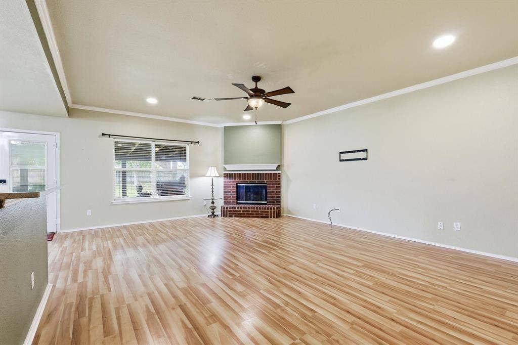 6421 Peak View Court, Midlothian, TX 76065 The living room is open to the kitchen with views of the back patio.