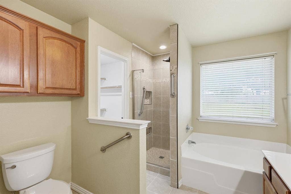 6421 Peak View Court, Midlothian, TX 76065 The primary bathroom is spacious with a separate tub and shower and large walk-in closet