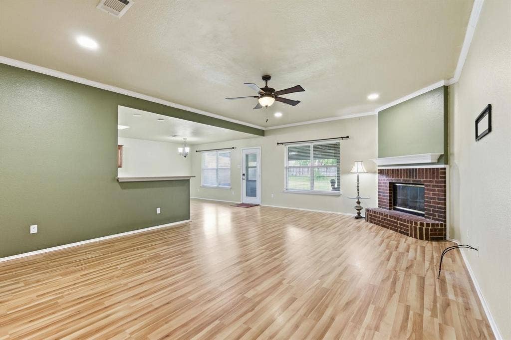 6421 Peak View Court, Midlothian, TX 76065 The living room has a cozy wood burning fireplace!