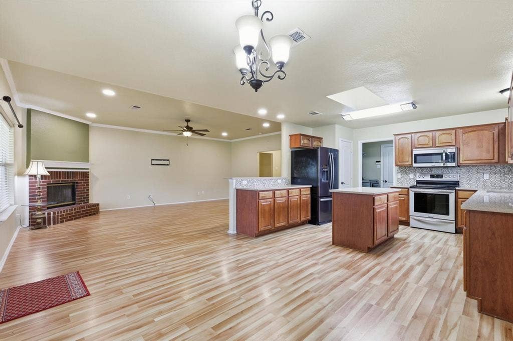 6421 Peak View Court, Midlothian, TX 76065 A view from the dining area toward the open kitchen and living area