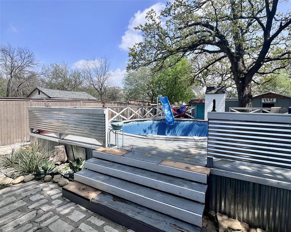 3020 Delaware Trail, Lake Worth, TX 76135 Wooden deck featuring a fenced in pool and fence
