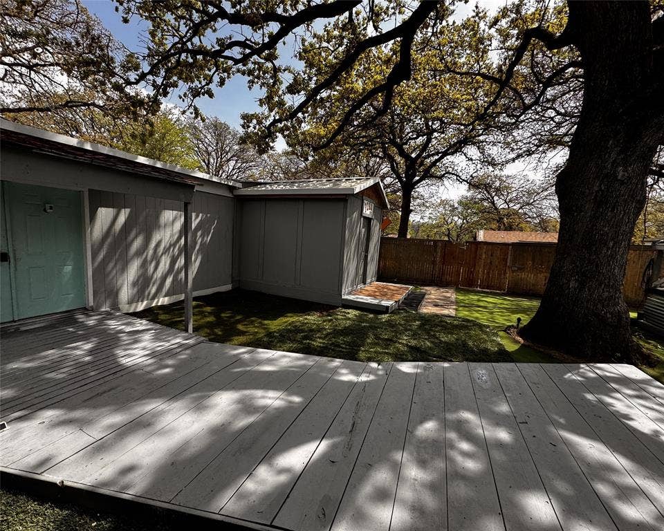3020 Delaware Trail, Lake Worth, TX 76135 Wooden deck featuring an outdoor structure, a fenced backyard, a shed, and a yard
