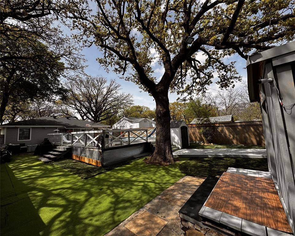 3020 Delaware Trail, Lake Worth, TX 76135 View of yard featuring a deck, an outdoor structure, fence private yard, and a shed