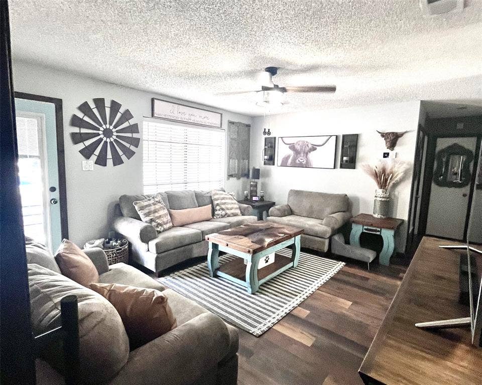 3020 Delaware Trail, Lake Worth, TX 76135 Living room with a ceiling fan, a textured ceiling, and wood finished floors