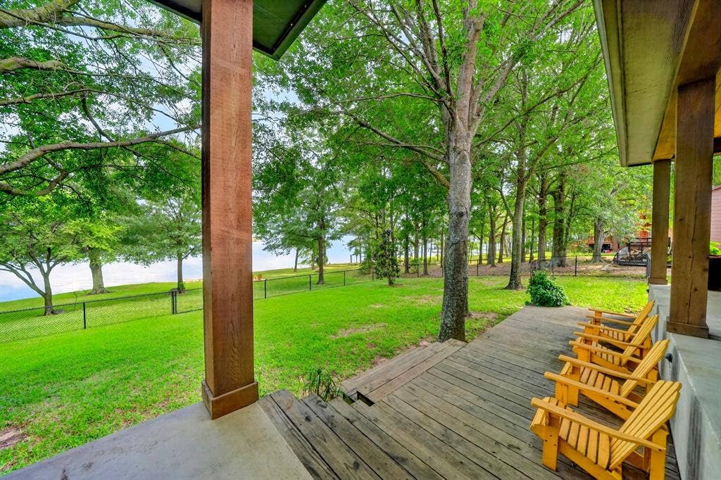 15491 Presidio Circle, Caney City, TX 75148 Expansive outdoor living area featuring a wood-finish deck, concrete steps, and substantial wood columns