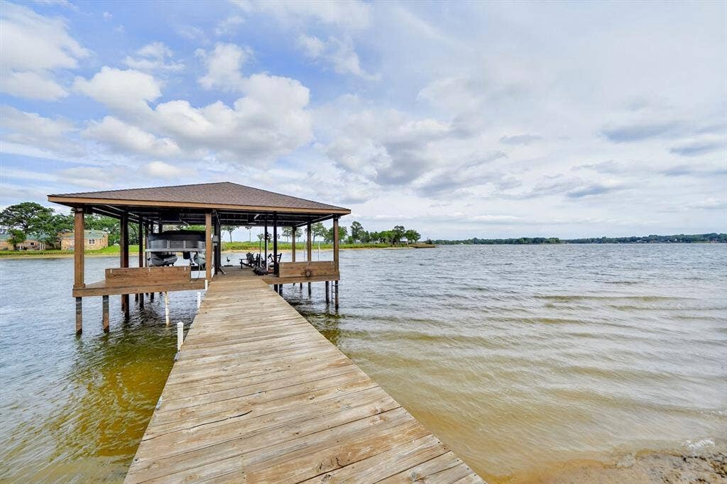 15491 Presidio Circle, Caney City, TX 75148 Expansive private dock with a covered boat slip, wood decking, and direct water access