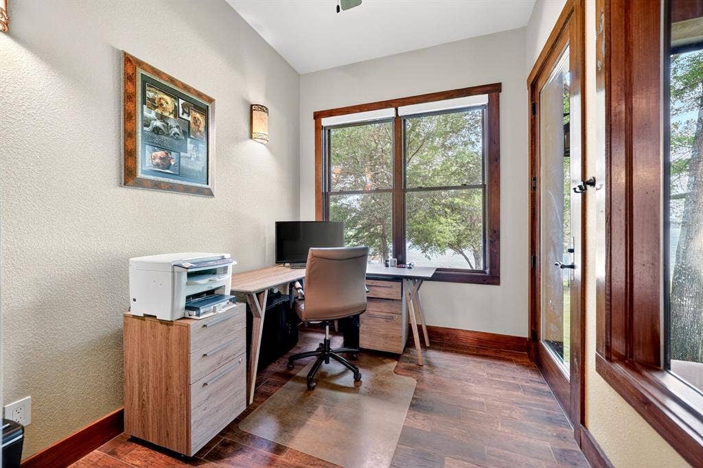 15491 Presidio Circle, Caney City, TX 75148 Room featuring wood-finish flooring, warm cream walls, and rich wood trim around windows and a glass-paneled door