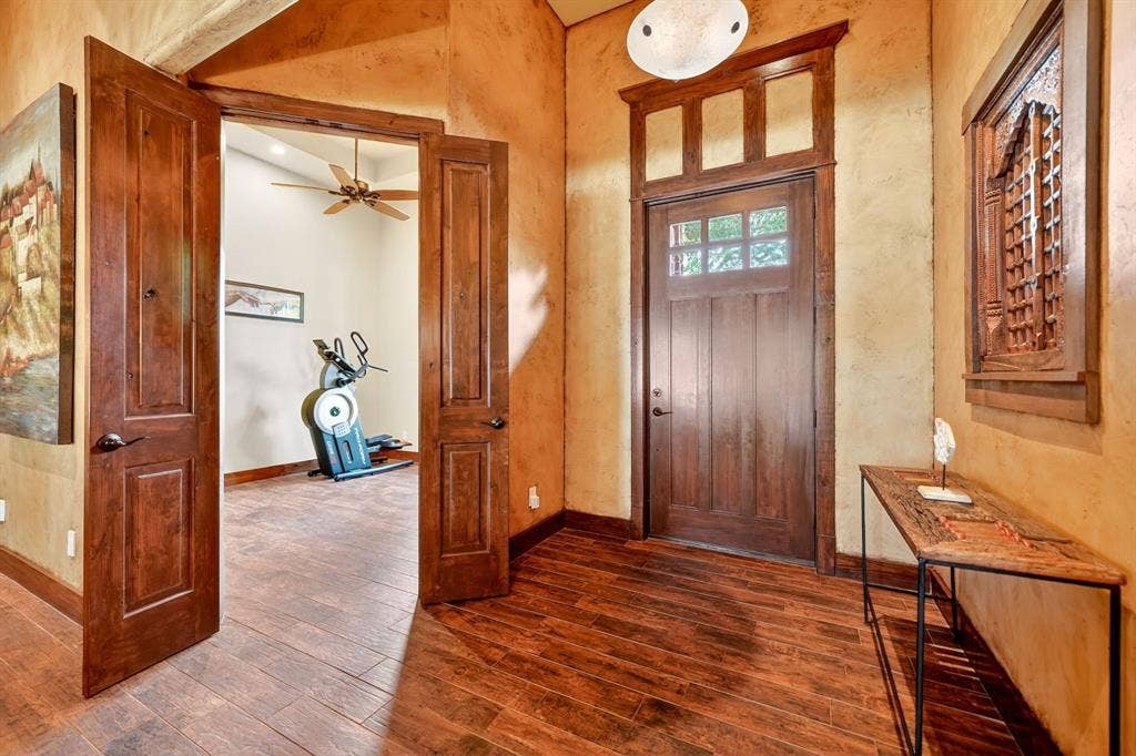 15491 Presidio Circle, Caney City, TX 75148 Entryway featuring wood-finish flooring, a solid wood entry door with transom windows, and textured wall finishes