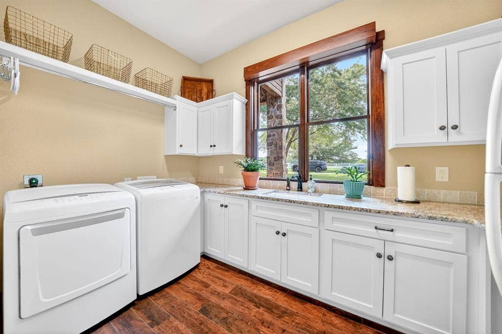 15491 Presidio Circle, Caney City, TX 75148 Utility room with wood-finish flooring, white cabinetry, and granite-style countertops