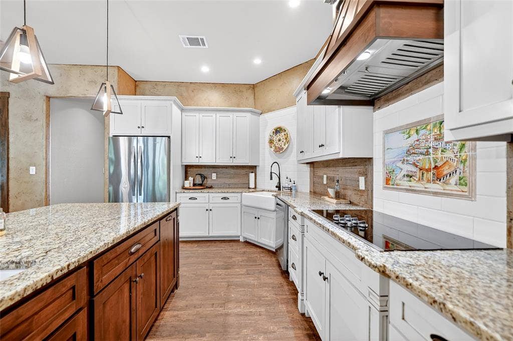 15491 Presidio Circle, Caney City, TX 75148 Kitchen featuring light-toned granite countertops, white cabinetry with dark hardware, and a wood-finish flooring