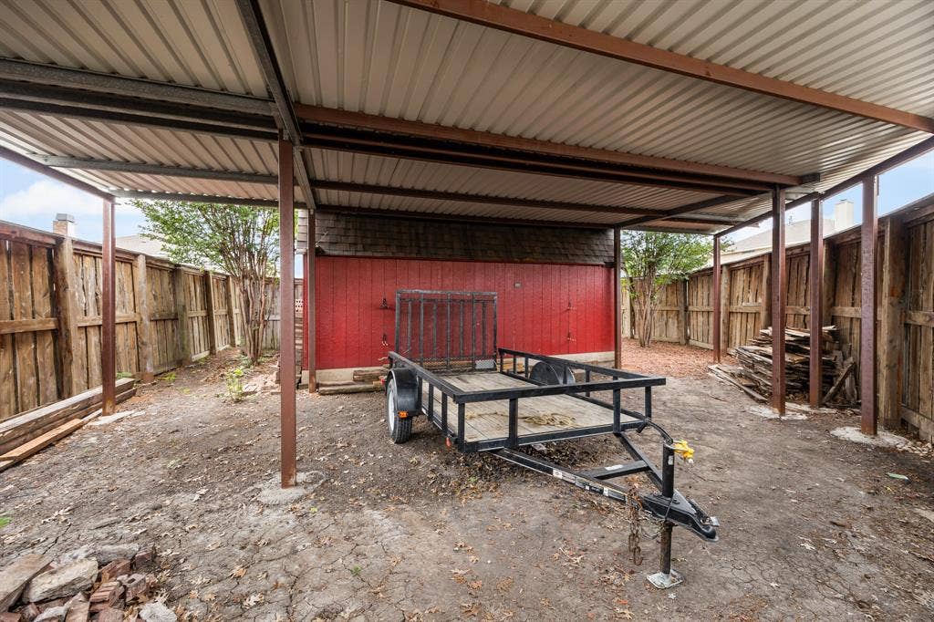 9209 Chimneywood Drive, Rowlett, TX 75089 Large (approx 40X21) gated carport with 9.5ft clearance.