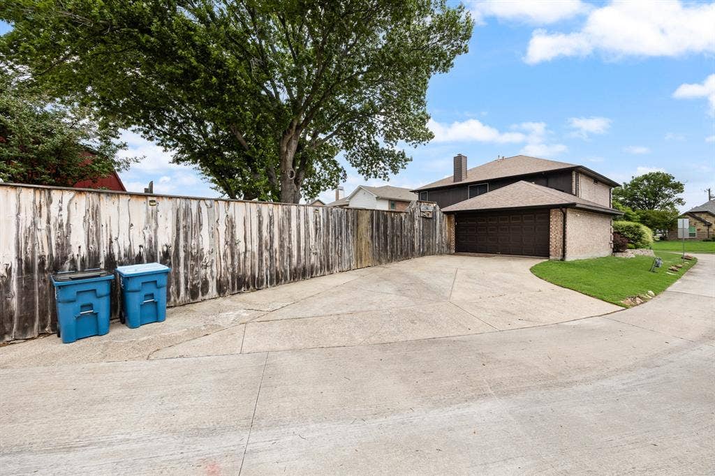 9209 Chimneywood Drive, Rowlett, TX 75089 Extra long driveway and easy to access secure parking behind the gated fence. Fence has