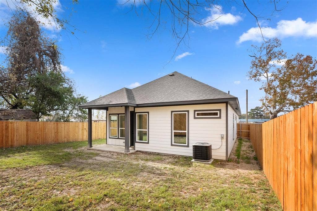 802.5 N Needmore Street, Athens, TX 75751 Rear view of house featuring roof with shingles, a patio, and a fenced backyard