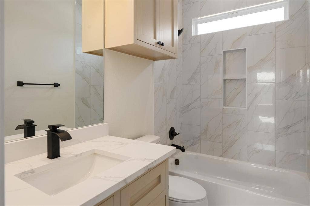 802.5 N Needmore Street, Athens, TX 75751 Bathroom featuring vanity and washtub / shower combination