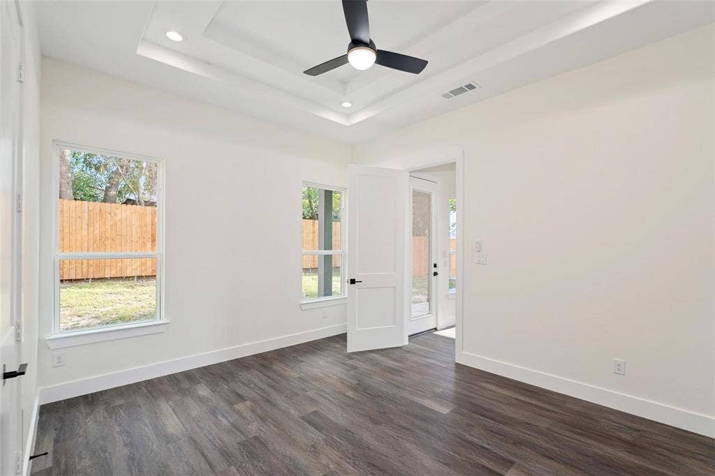 802.5 N Needmore Street, Athens, TX 75751 Spare room featuring plenty of natural light, dark wood-style floors, ceiling fan, and recessed lighting