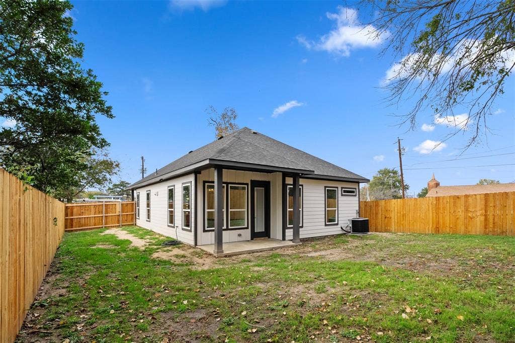 802.5 N Needmore Street, Athens, TX 75751 Rear view of house with a patio area, a fenced backyard, and roof with shingles