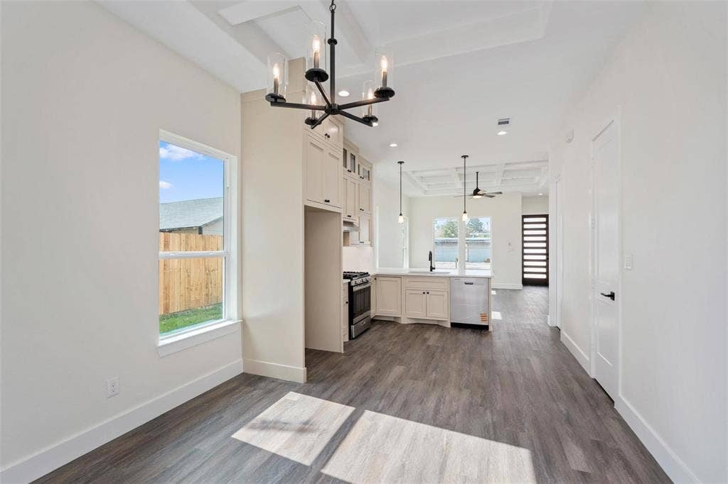 802.5 N Needmore Street, Athens, TX 75751 Kitchen featuring light countertops, dark wood-style flooring, suspended lighting, stainless steel appliances, and glass fronted cabinets