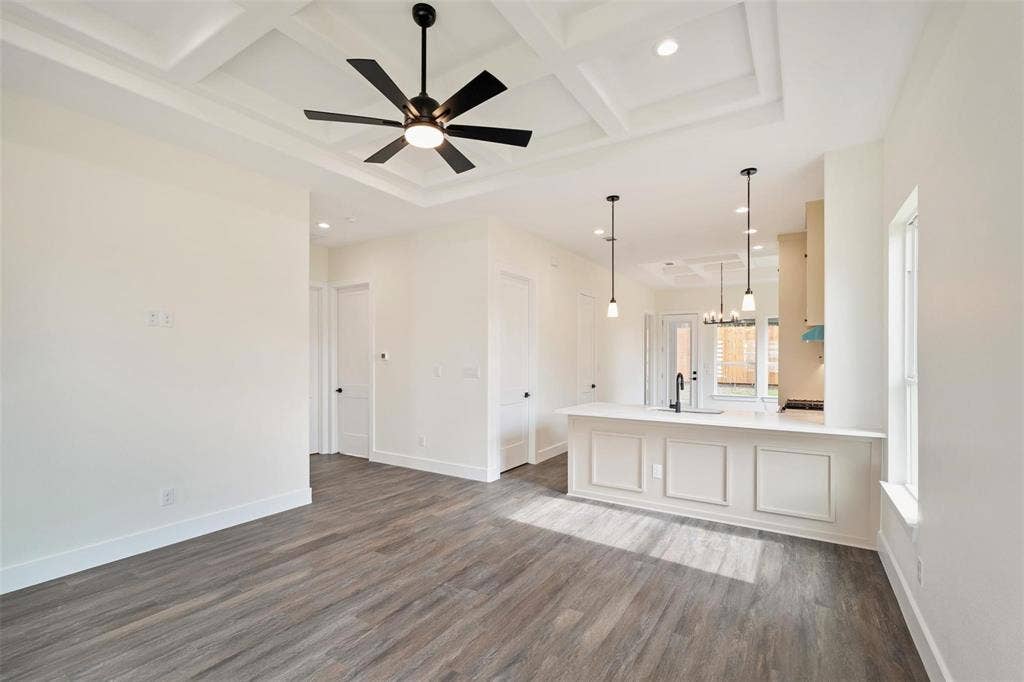 802.5 N Needmore Street, Athens, TX 75751 Unfurnished living room with a ceiling fan, coffered ceiling, dark wood finished floors, and hanging lights