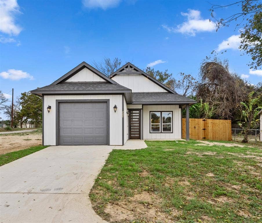 802.5 N Needmore Street, Athens, TX 75751 View of front of house with a shingled roof, an attached garage, driveway, and a gate