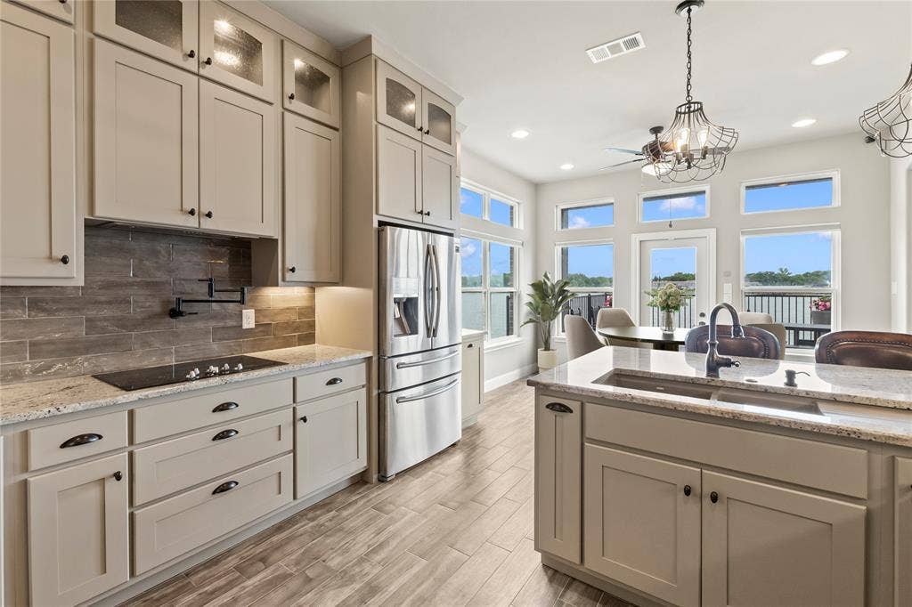 164 Marina Drive, Mabank, TX 75156 Staged Photo* Cooktop and beautiful granite counter tops, tile back splash and good cabinet storage.