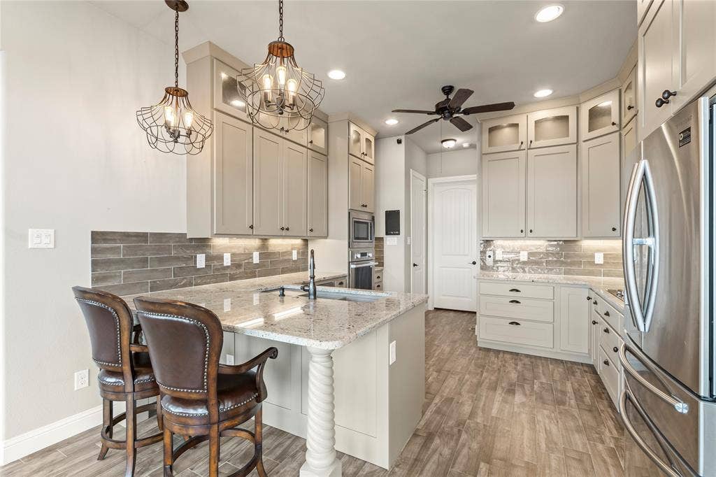 164 Marina Drive, Mabank, TX 75156 Illuminated custom cabinetry with soft close drawers, Rev-A-Shelf pullouts, Blanco sink with pot filler and Fisher and Paykel dish drawer.