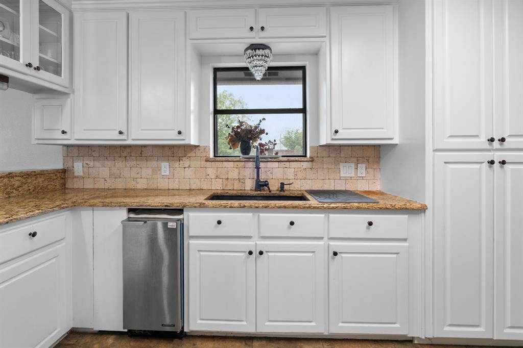4200 Jennifer Lane, Crowley, TX 76036 Kitchen featuring white cabinetry, light stone countertops, tasteful backsplash, and glass insert cabinets