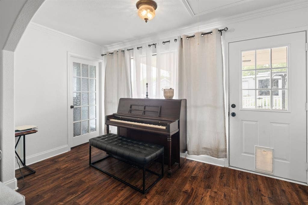 4200 Jennifer Lane, Crowley, TX 76036 Living area featuring crown molding, dark wood-style floors, and arched walkways