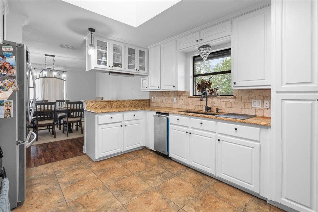 4200 Jennifer Lane, Crowley, TX 76036 Kitchen featuring glass insert cabinets, light stone counters, white cabinetry, and stainless steel appliances
