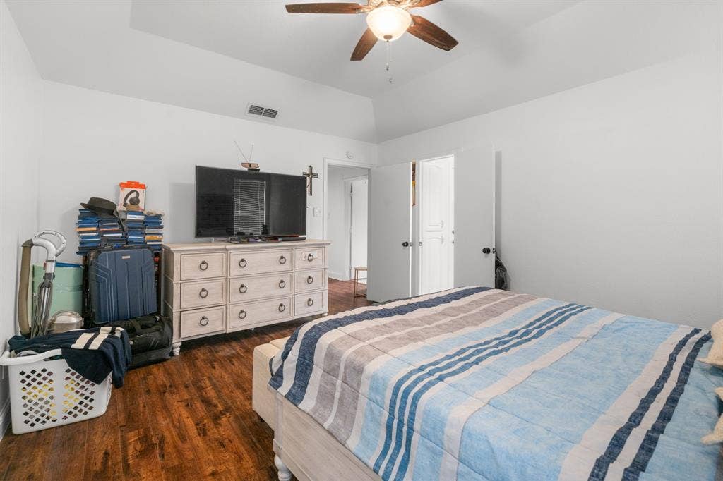 4200 Jennifer Lane, Crowley, TX 76036 Bedroom with dark wood-style floors, ceiling fan, and vaulted ceiling