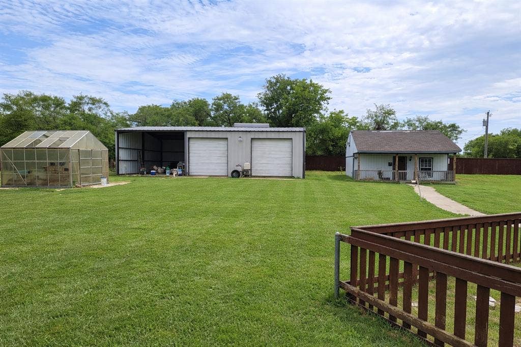 4200 Jennifer Lane, Crowley, TX 76036 View of yard with an outdoor structure, a garage, and a greenhouse