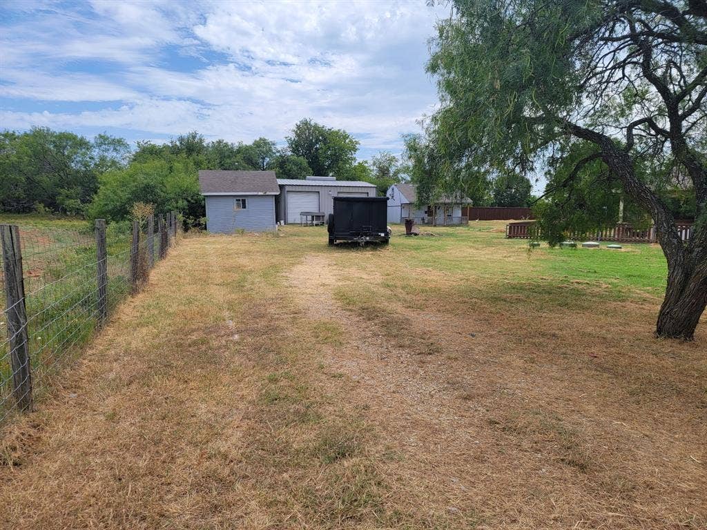 4200 Jennifer Lane, Crowley, TX 76036 View of yard with a garage and driveway