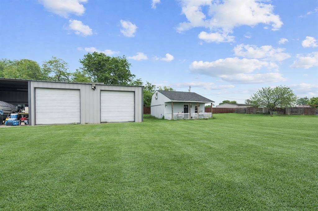4200 Jennifer Lane, Crowley, TX 76036 View of yard with an outdoor structure and a detached garage