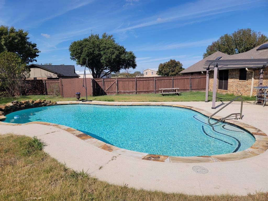 4200 Jennifer Lane, Crowley, TX 76036 View of swimming pool with patio surround, a fenced backyard, and a pergola