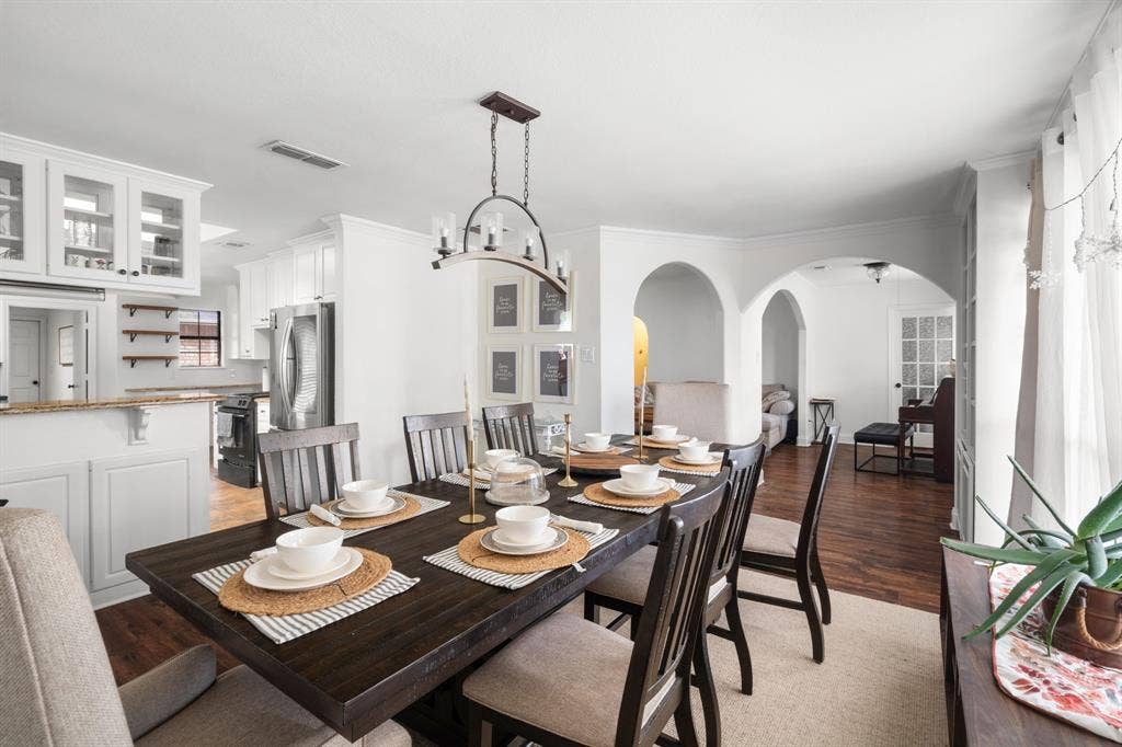 4200 Jennifer Lane, Crowley, TX 76036 Dining room featuring arched walkways, light wood-style flooring, and hanging lights