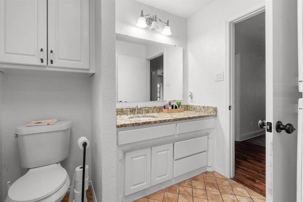 4200 Jennifer Lane, Crowley, TX 76036 Half bathroom featuring vanity, a textured wall, and light tile patterned floors